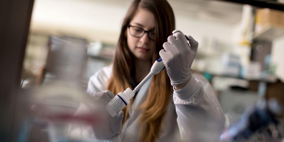 chemistry student in a lab performing an experiment