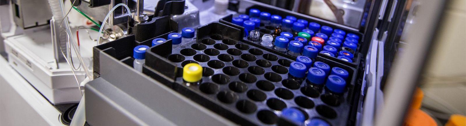 A series of test tubes in a machine at a research lab in the College of Science and Technology at Temple.