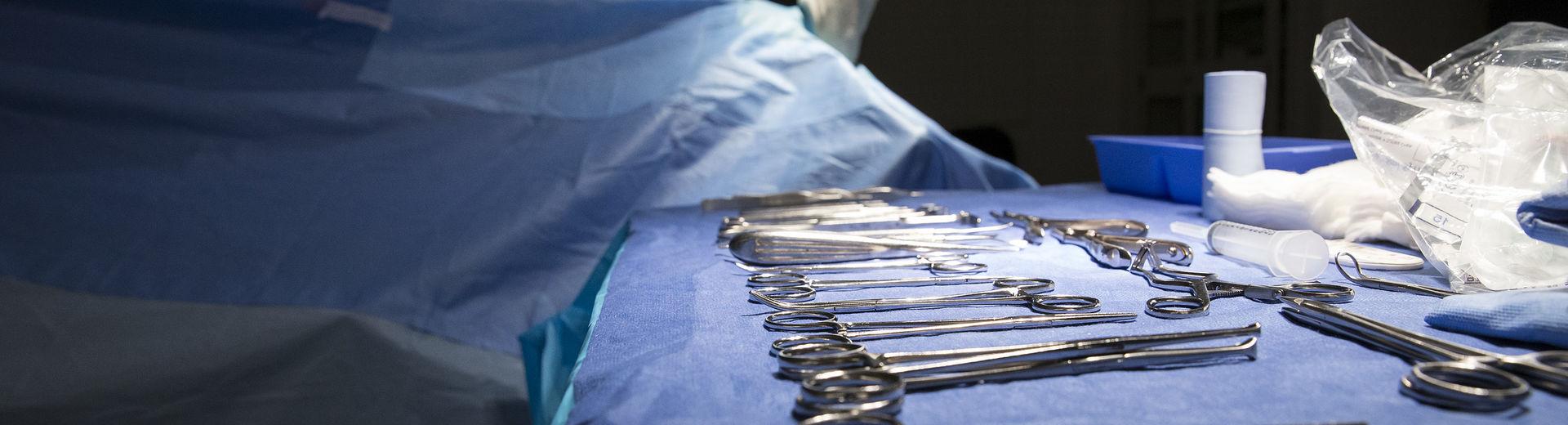 Podiatric surgical tools on a table in an operating room.