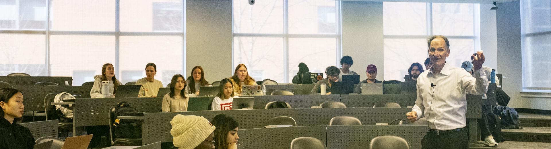 Fox professor instructs a classroom of students.